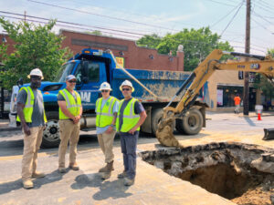 Jesse Jewell standing with other field crew workers