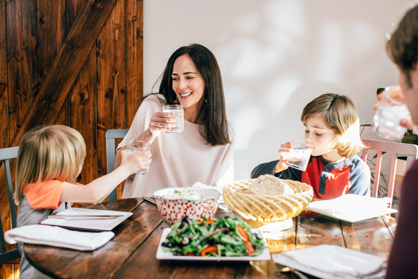 family at table drinking water