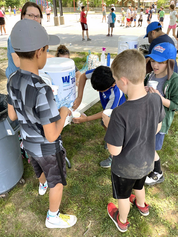students drinking water at field day