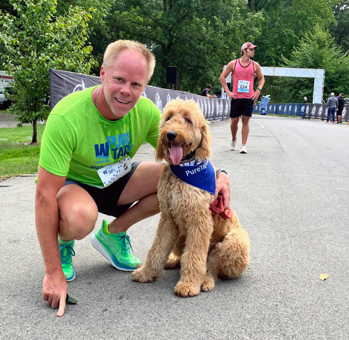 runner with dog at Pure Tap 5k