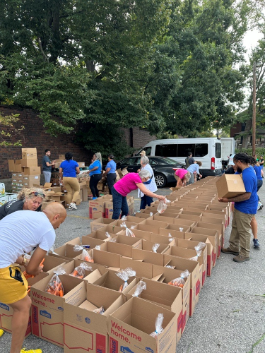 Volunteers packing food boxes at Kentucky Refugee Ministries