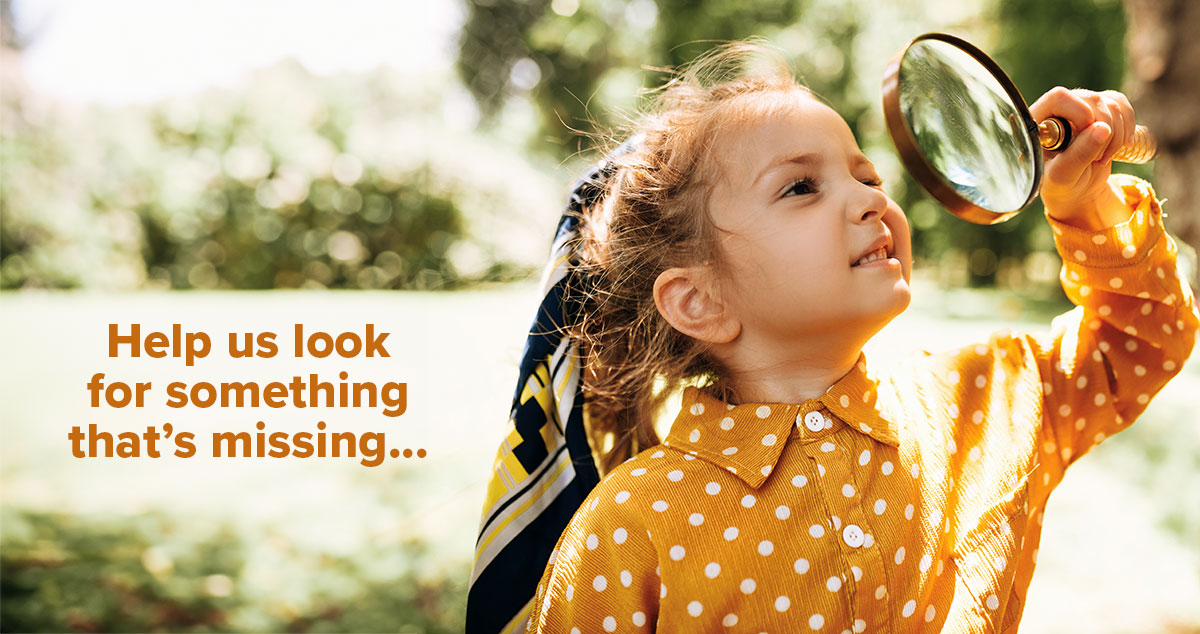 Young girl looking through magnifying glass