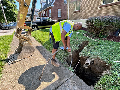 man working with lead pipe