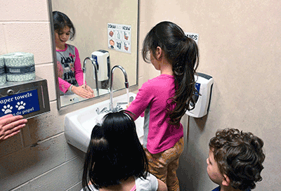 Auburndale elementary student cleaning hands