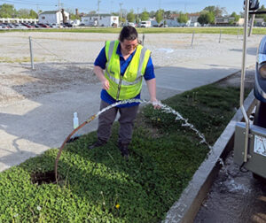 Crew member taking water sample