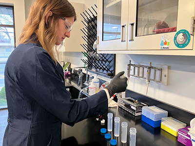 LW lab employee testing water samples