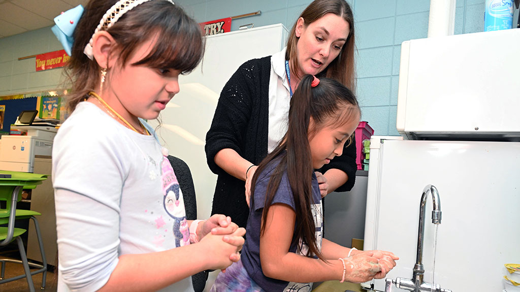 Heather instructing students how to clean hands