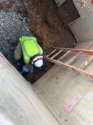 Crew member down in hole fixing main break