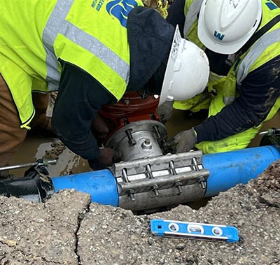 Crew fixing a main break