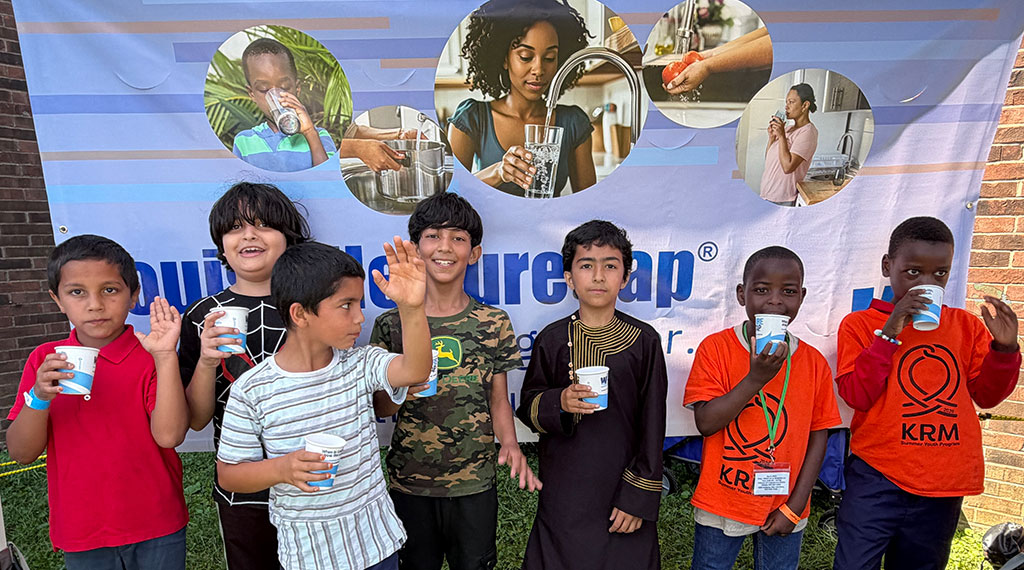 Kids raise Pure Tap cups