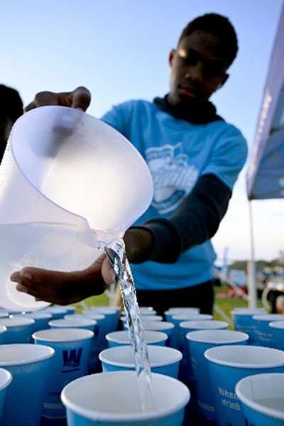 Boy pouring water