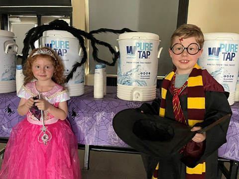 Meghan Brown's children next to Pure Tap water coolers